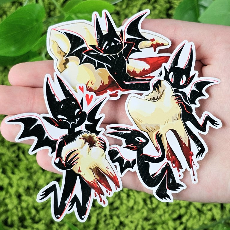 Three Teeth Demon stickers in Milky's hand