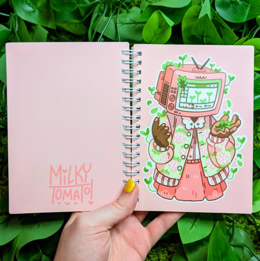 Front and back of Strawberry Sprout TV head sticker book in Milky's hand